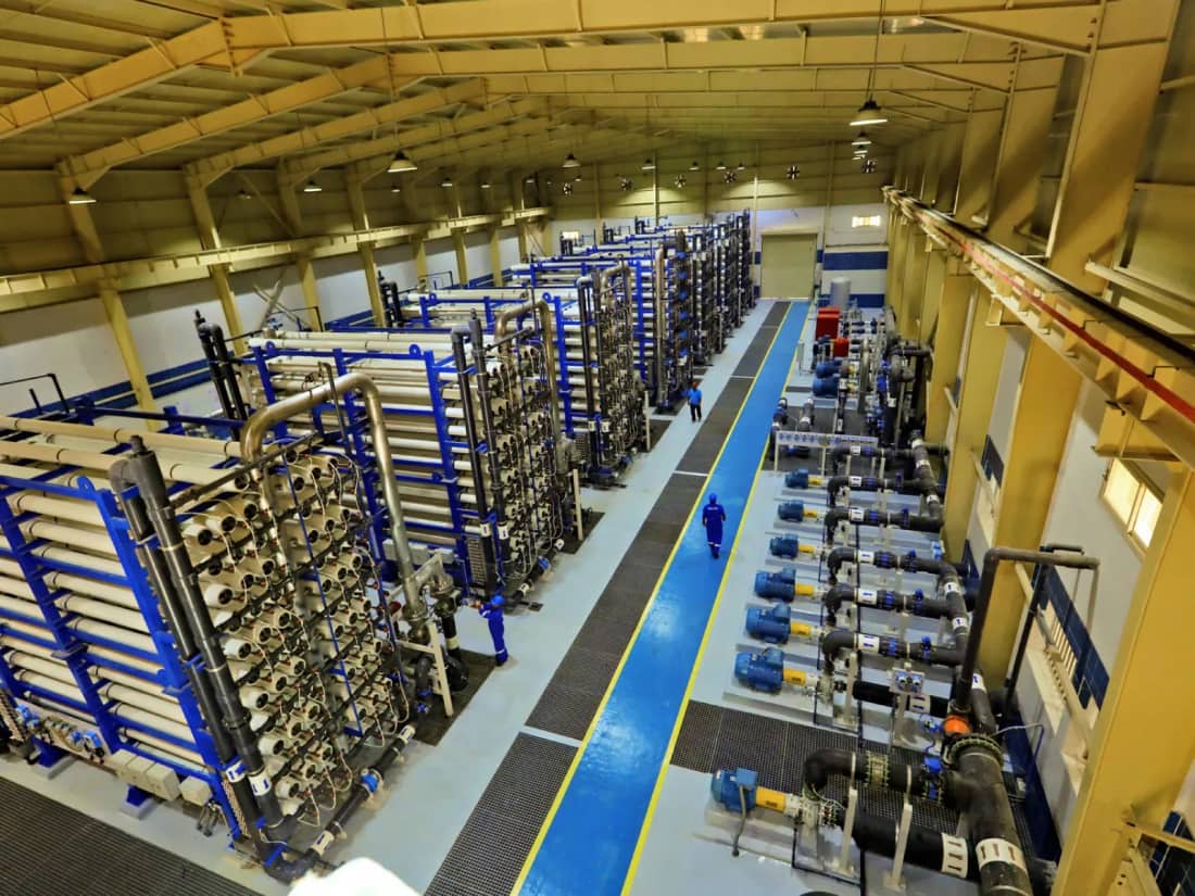 Industrial reverse osmosis plant hall with RO pressure vessel racks and high-pressure pumps