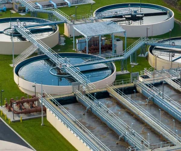 Sewage treatment plant with circular clarifiers, aeration basins and walkways