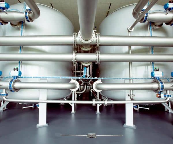 Water treatment plant with stainless steel pressure filters and manifold piping